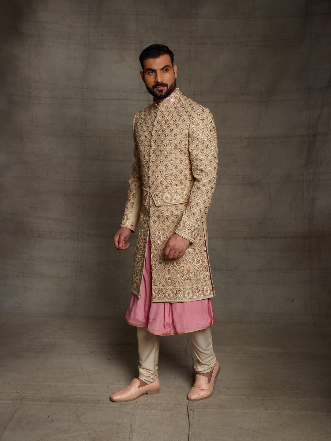Gold sherwani with symmetric design and traditional kamarbandh