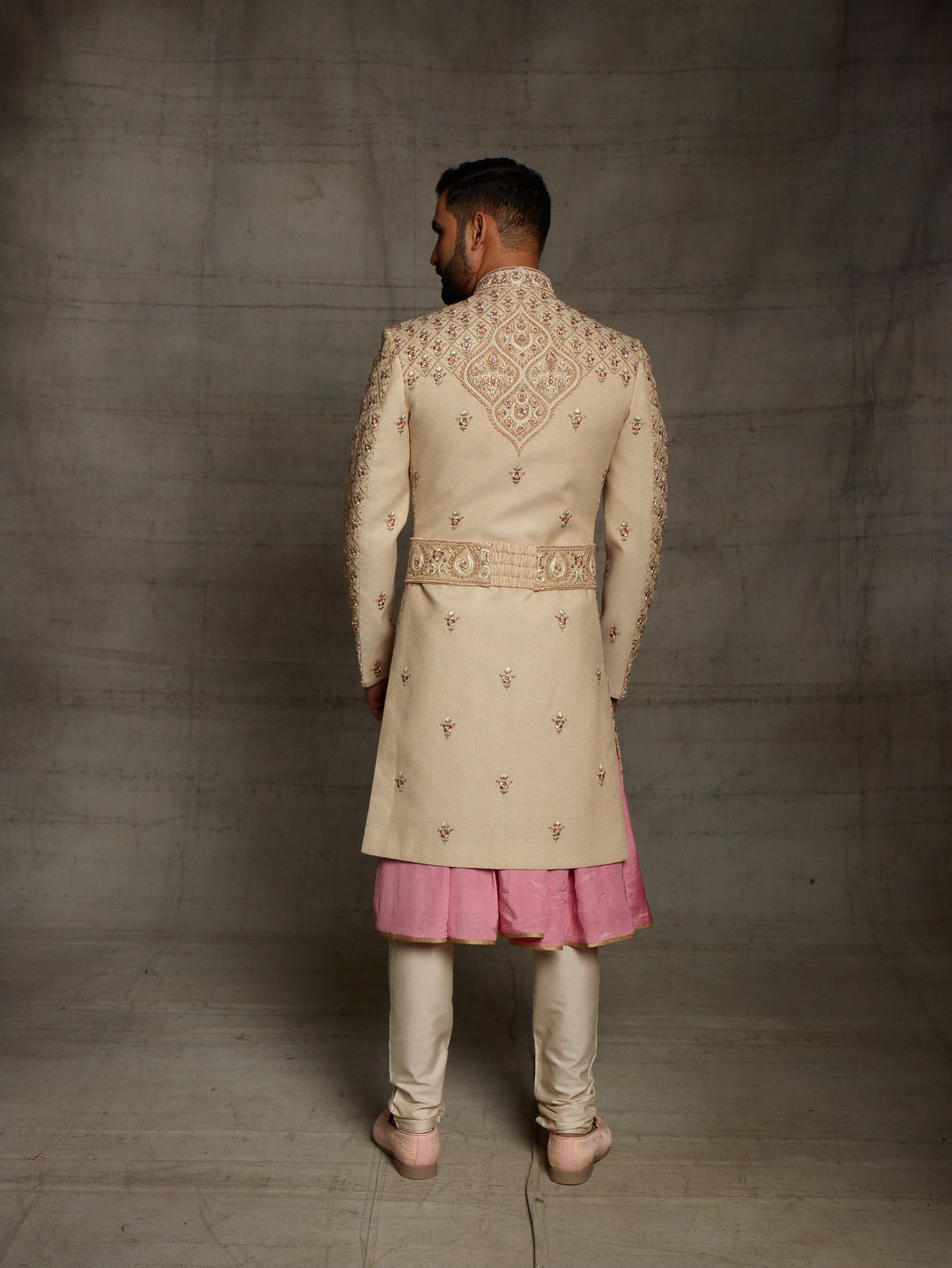 Gold sherwani with symmetric design and traditional kamarbandh