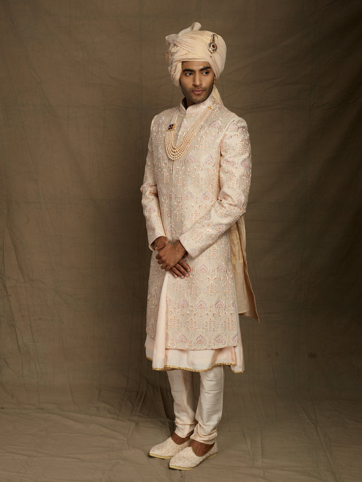 Peach groom's wear sherwani.