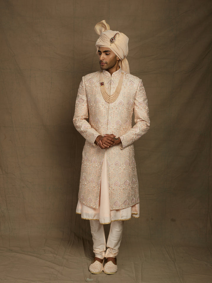Peach groom's wear sherwani.