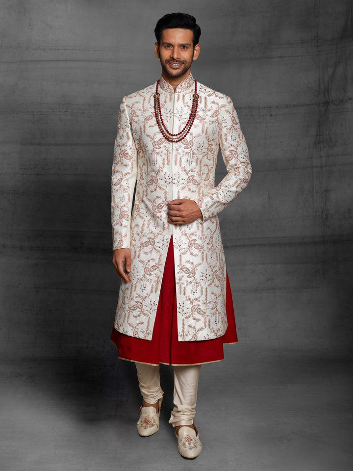 Classic white-maroon combination sherwani with overall jaal work.