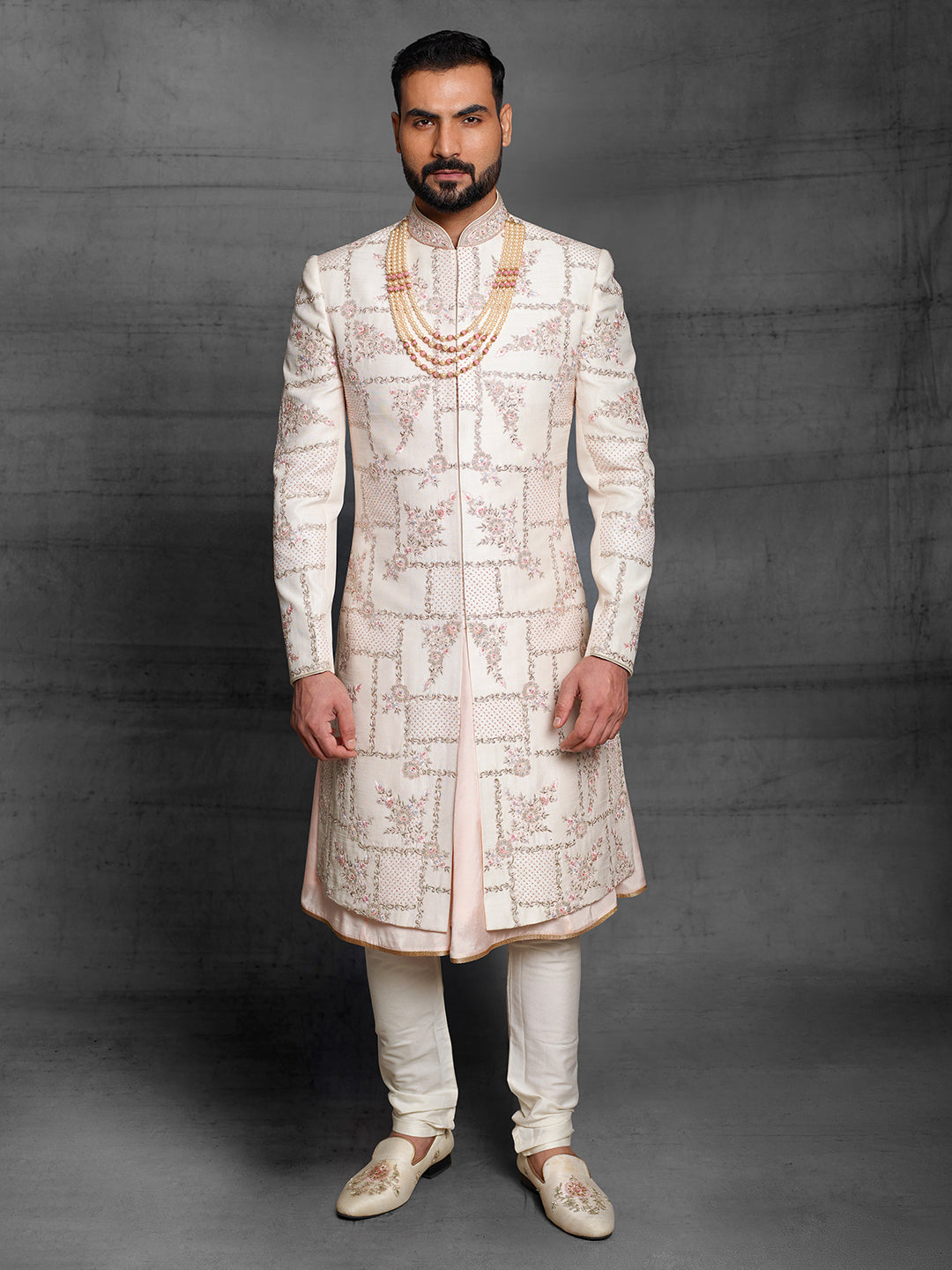 Light peach grooms wear sherwani with geometric design.