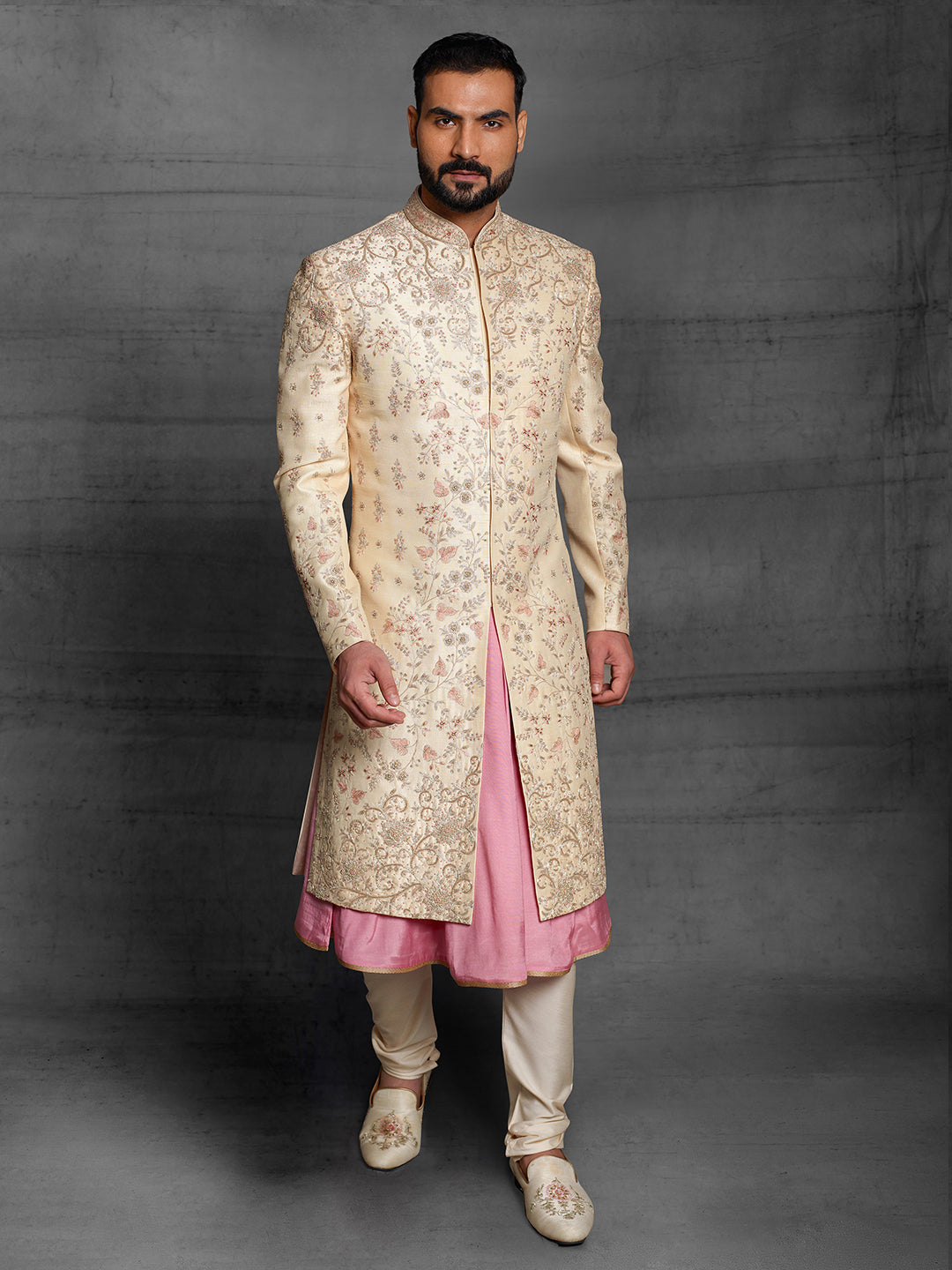 Gold groom's wear sherwani with pink highlights.