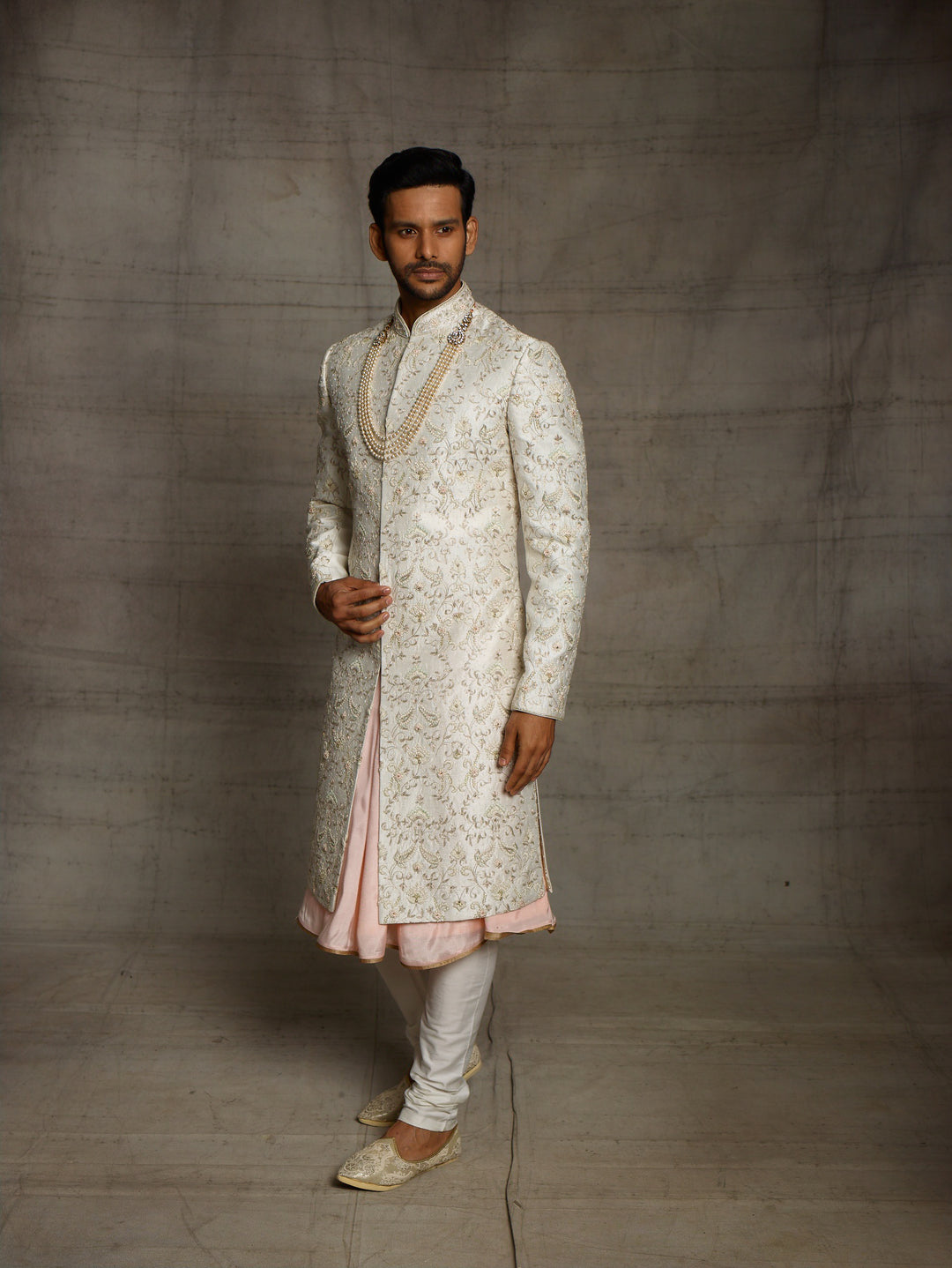 Ivory sherwani with overall resham work floral jaal.