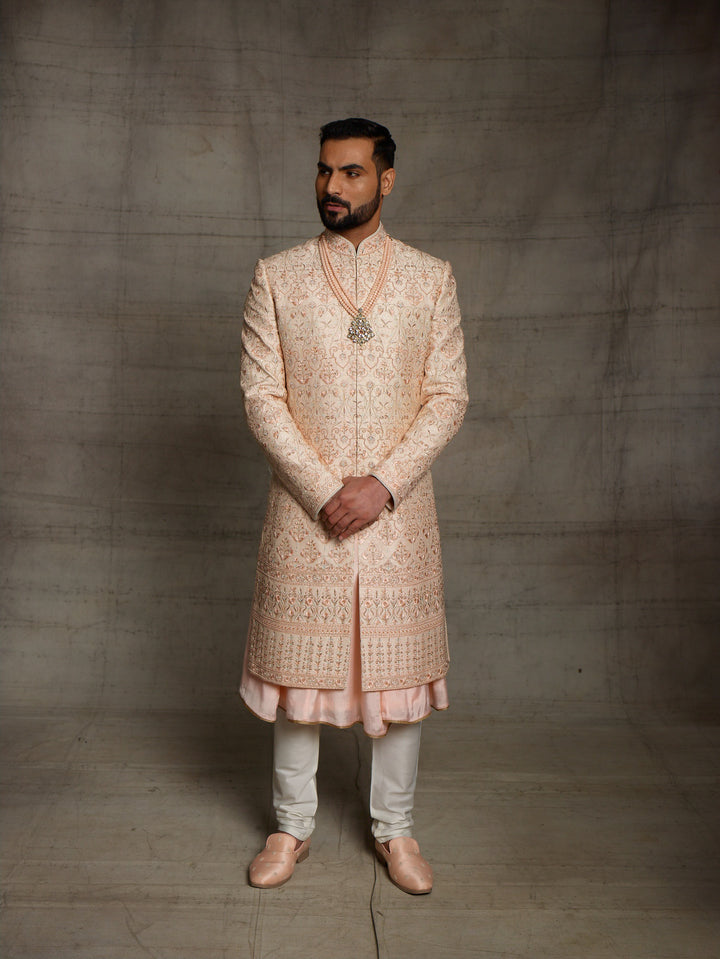 Peach sherwani with metallic rose gold resham embroidery.