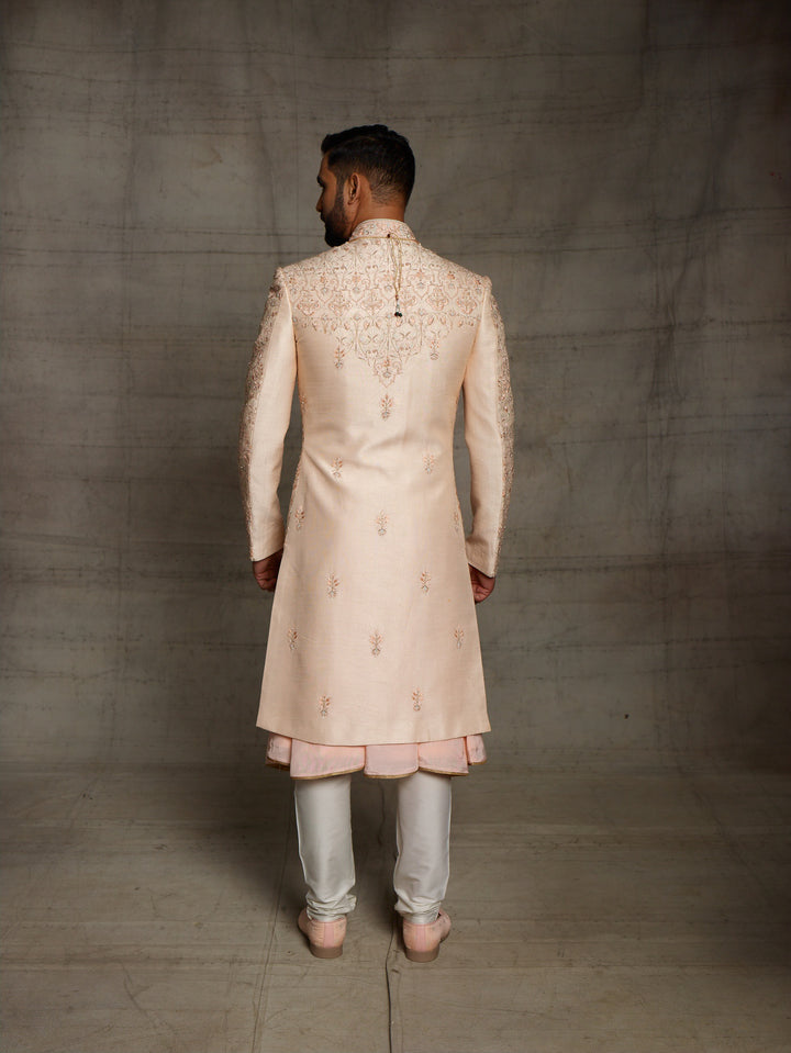 Peach sherwani with metallic rose gold resham embroidery.