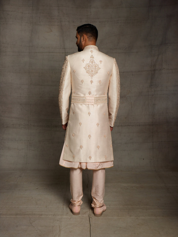 Overall embroidered sherwani in light gold color.