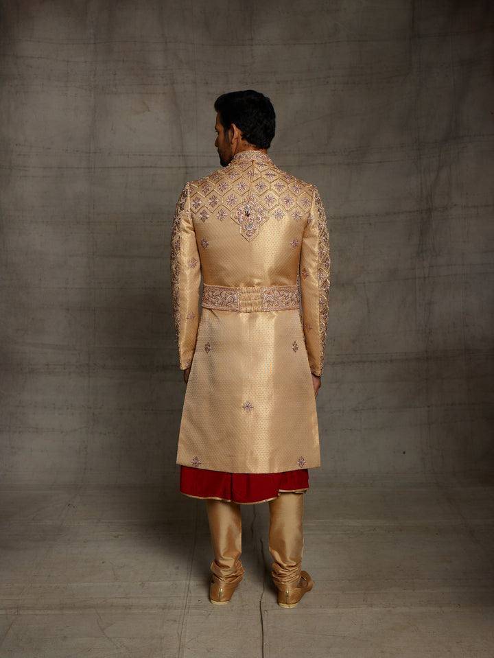 Traditional gold maroon sherwani with heavy zardose embroidery.