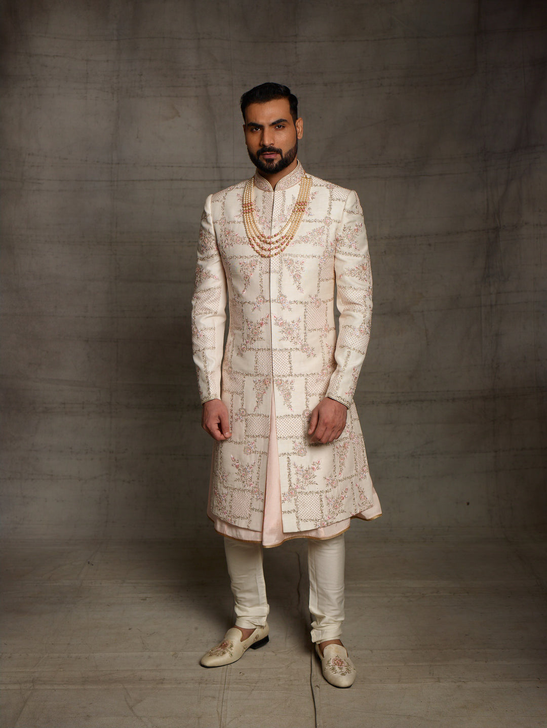 Light peach grooms wear sherwani with geometric design.