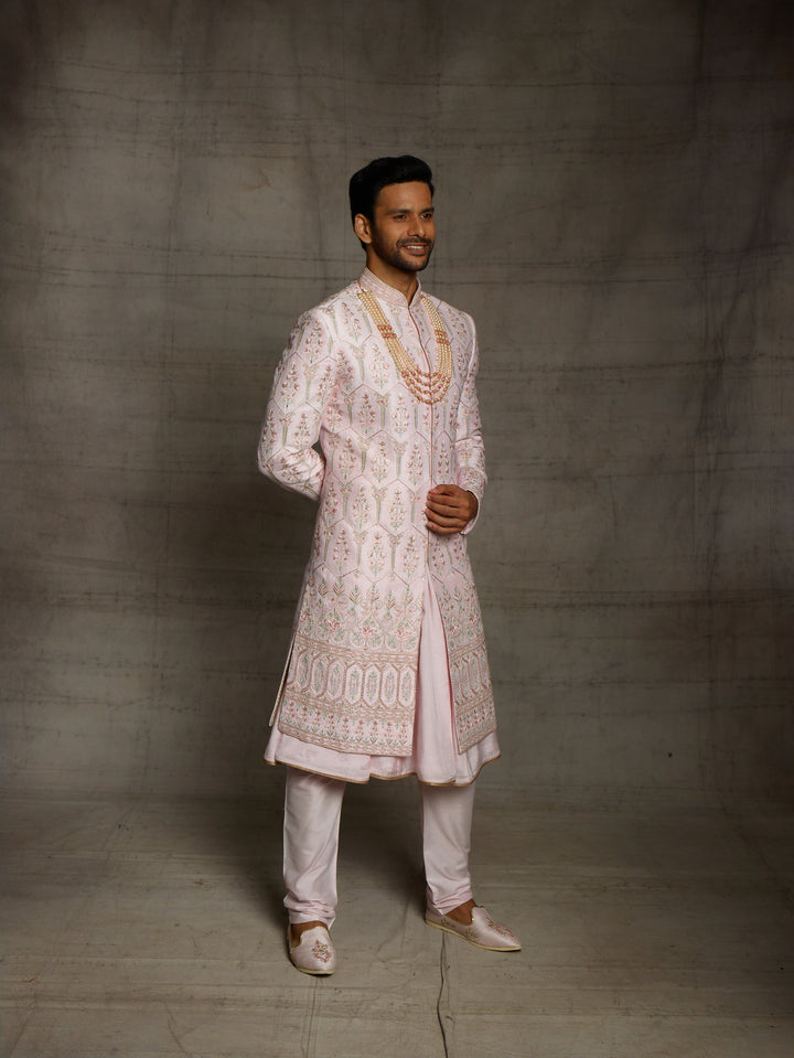 Designer groomwear sherwani in powder pink color.