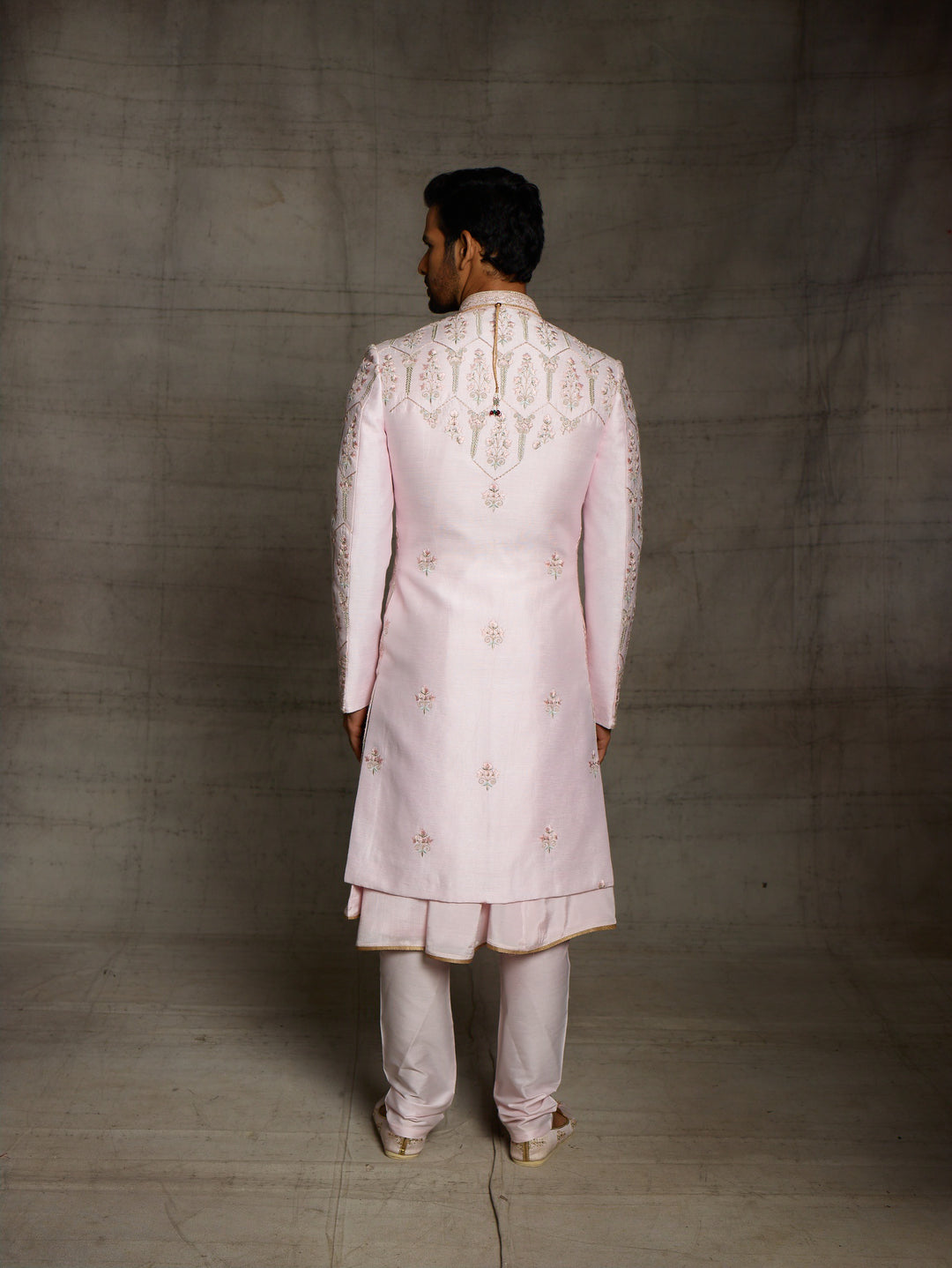 Designer groomwear sherwani in powder pink color.